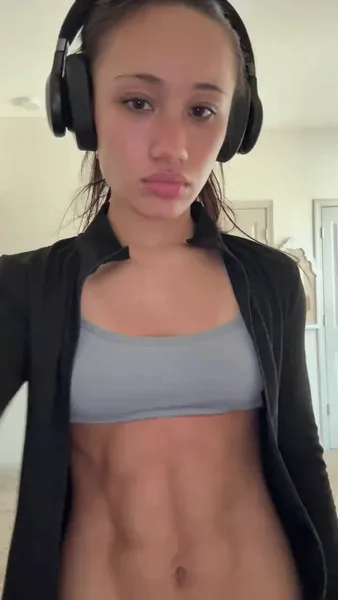 Headphones on, abs out.